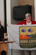 Carl Schwartz presents the flags to Madison and Maple Bluff.