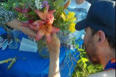 Andy, a participant in Gardening for Good, arranges a bouquet (Sean Kirkby/Madison Commons)