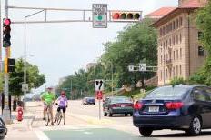 Cyclists wait for a green light and Park and University (Xin Wang/Madison Commons)