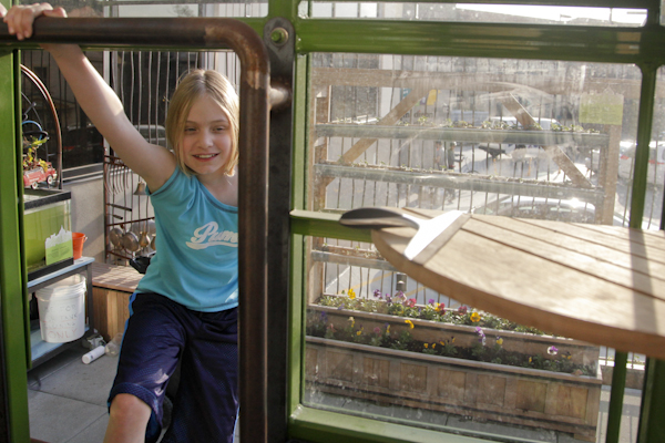 Emily Shields plays in the greenhouse at the Madison Children's Museum, caring for some recently potted flowers during Day in a Kid's Life, an event aimed at documenting first-person perspectives of childhood (Kait Vosswinkel/Madison Commons)