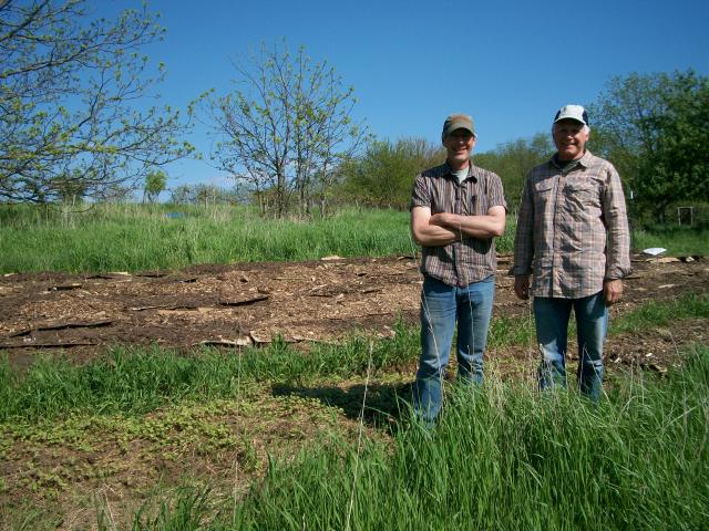 Shedd Farley, left, and Ronald Schell stand in a gooseberry field at the Farley Center in Verona. These gooseberries will be sent to local food pantries in an effort to expand access to fresh produce (Jennifer Gragg/Madison Commons).