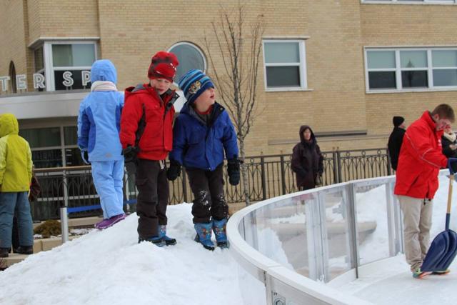 Prairie du Sac brothers play in the snow near the Edgewater ice rink while they wait for a speed skating demonstration as well as a figure skating show. More photos are available on Madison Common's Facebook page. (Rebecca Radix/Madison Commons)