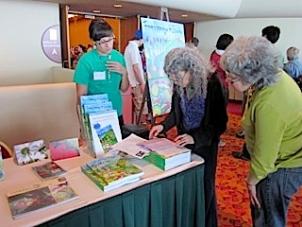 Open house attendees stop to look at the MACSAC cookbook.