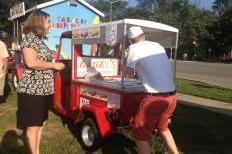 Andrew Tyink, co-owner of Dandy's Frozen Treats, serving organic treats at Meadowood.