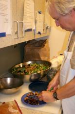 Slow Food Madison member David Griffeath prepares a salad