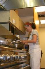 Private chef and Slow Food member Naomi Kroenke prepares a meal at Goodman Community Center