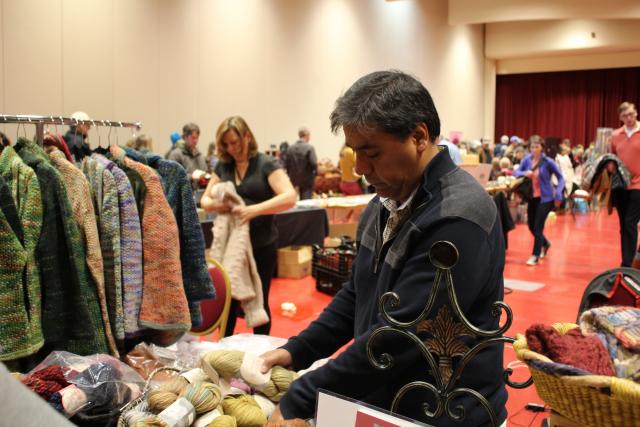 Miguel Paz of Misti International organizes his alpaca and alpaca blend yarns. (Becca Radix/Madison Commons)