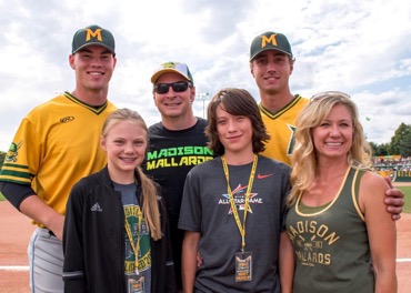 (The Hurley family with Madison Mallards players Luke Shilling, left, and Thomas Smart, right).