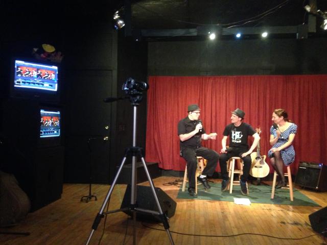 Red Dragon TV founder Ari-John White-Wolf, left, interviews a band during a performance of Inna Godda Davida (Esta Pratt-Kielley/Madison Commons)