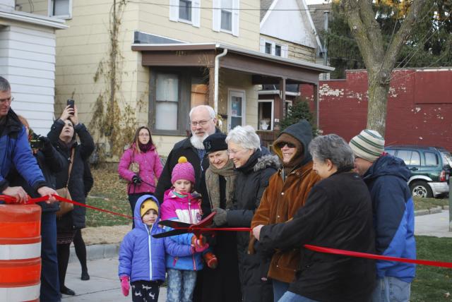 Tenney-Lapham Neighborhood Association president Patty Prime (black cap), Ald. Ledell Zellers (holding scissors), and Madison Mayor Paul Soglin cut a ribbon to open the Jam on Johnson.