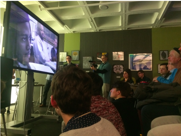 Visitors watched a documentary created by Marc Kornblatt of Refuge Films about the creation of the exhibition. (Melissa Behling/Madison Commons)