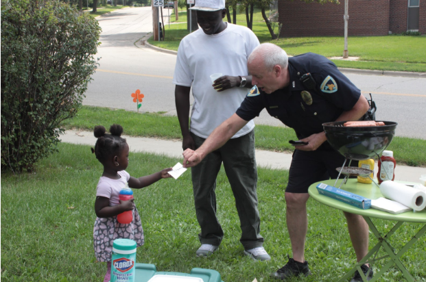 Officer Dexheimer handed out “Junior Officer” stickers to children at the event. (Kate Jungers/Madison Commons)