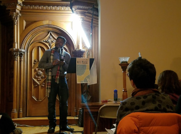 Derrick Austin reads an original piece of poetry to attendees. (Claire VanValkenburg/Madison Commons)