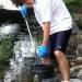 Josh Weber fishes trash out of Monona Bay.