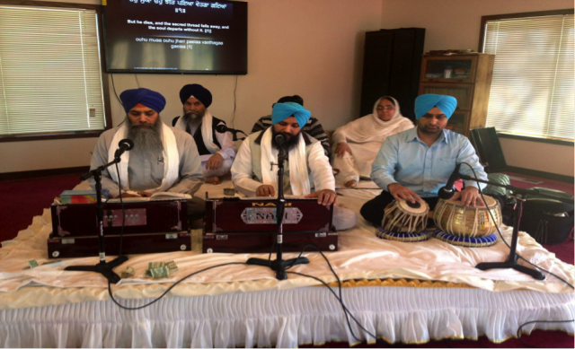 Satwant Kaur (back right) participates in the first morning prayer.