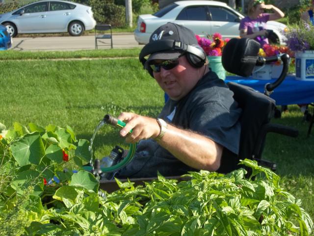 Steve, a participant in Gardening for Good, waters plants at Troy Community Gardens (Sean Kirkby/Madison Commons)
