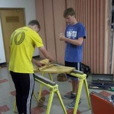 Members of Boy Scouts Troop 34 build a bench out of urban wood that will sit outside Trinity Lutheran Church (Sean Kirkby/Madison Commons)