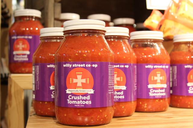 Jars of crushed tomatoes from local farms on display at Willy Street Co-op’s east side location. Frozen squash and broccoli are available at Willy Street Co-op stores as well. (Rebecca Radix/Madison Commons)
