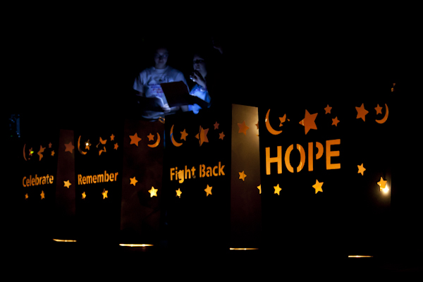 As survivors share their stories, the stage is lit by paper bags illustrating Relay for Life's four main themes: celebrate, remember, fight back and hope (Kait Vosswinkel/Madison Commons)