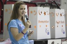: Madeline Bireley, a co-director of the luminaria portion of Relay for Life, closes the ceremony and introduces one of the night's performance groups (Kait Vosswinkel/Madison Commons)
