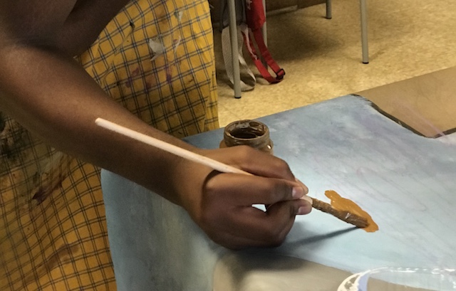 A student contributes to a mural for Madison's South Police Station at Hoyt School (Erin Green/Madison Commons).