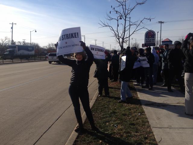 Madisonians gather outside the Taco Bell on East Washington to demand a living wage for fast food workers (Photo by Jackson Foote)