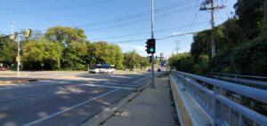 Sidewalks, busses, and cars at the University Ave intersection.