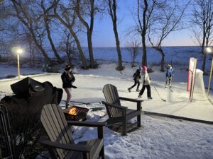 Hayden (far left) and Jake (far right) playing hockey on the ice rink with some neighbors.