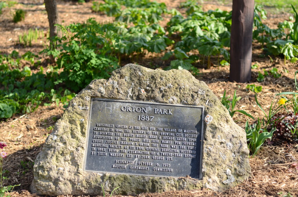 A plaque affixed to a stone at Orton Park’s southwest entrance