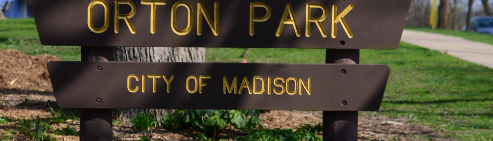 A wooden sign at Orton Park’s southwest entrance welcomes visitors to the Madison’s first park.