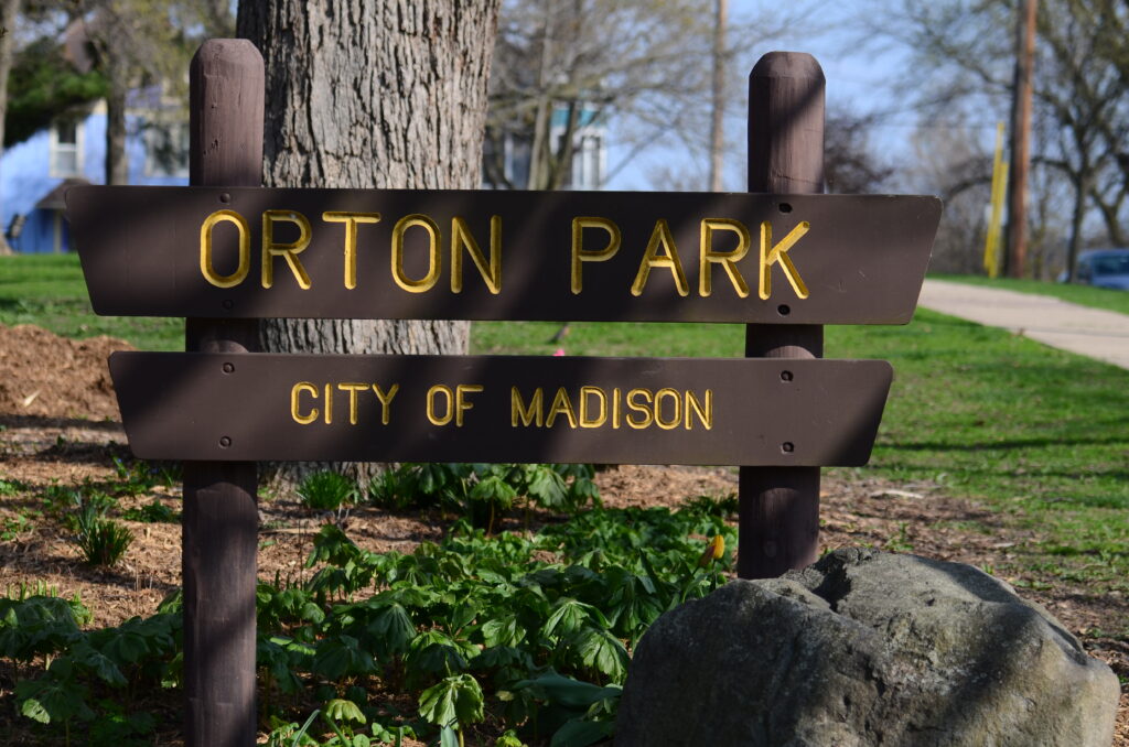 A wooden sign at Orton Park’s southwest entrance welcomes visitors to the Madison’s first park.