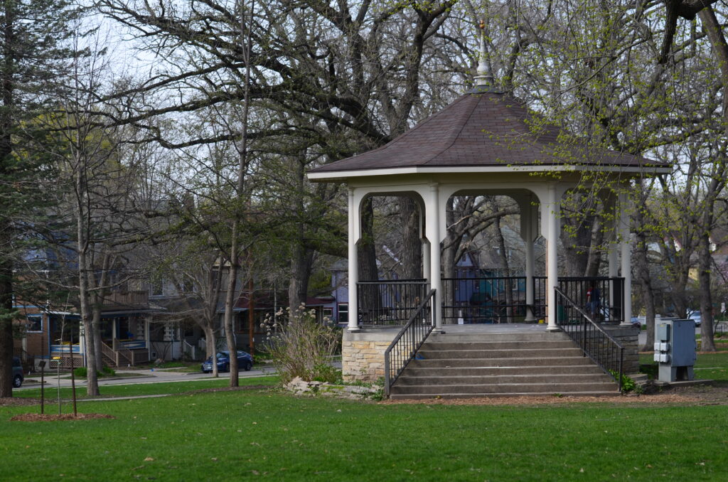 An eight-sided gazebo along a paved path serves as the centerpiece for Orton Park in Madison, Wis.