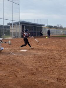 Verona pitcher, Blomberg hitting the ball on a line to right-center field.