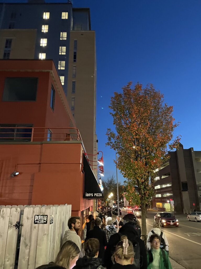 Voters wait for free Ian's pizza