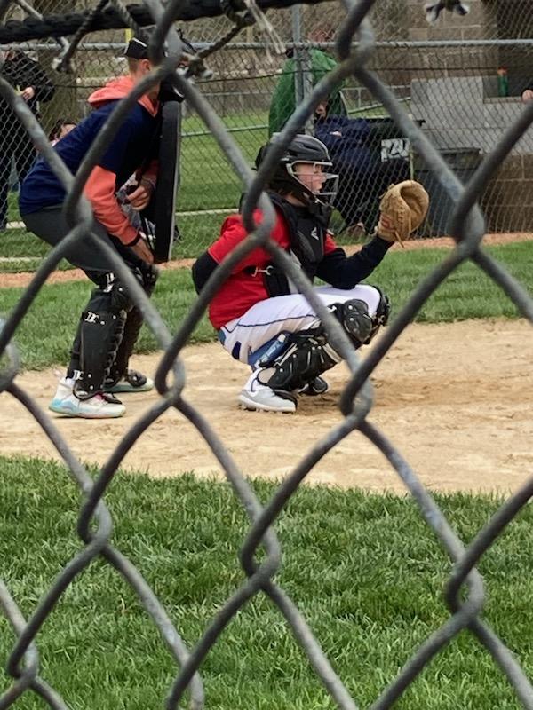 A catcher in Dane County's Kennedy Little League prepares to field a pitch.