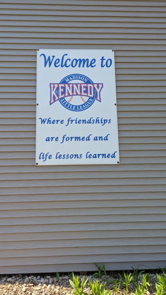 Sign for Kennedy Little League that says "Where friendships are formed and life lessons learned."