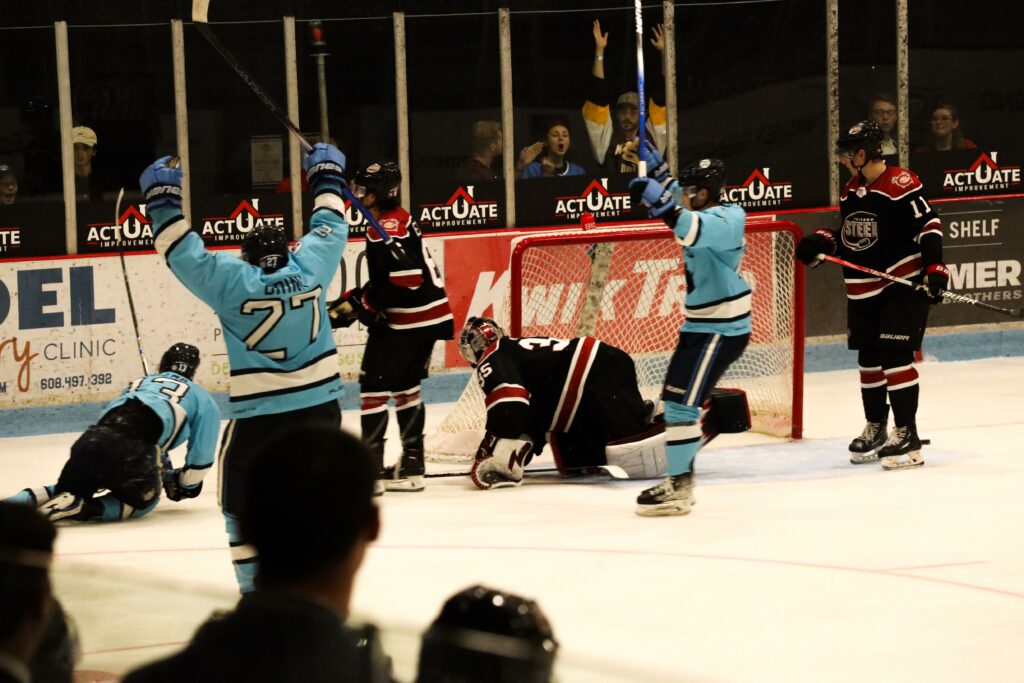 The Madison Capitols celebrate a goal scored in their home opener. 