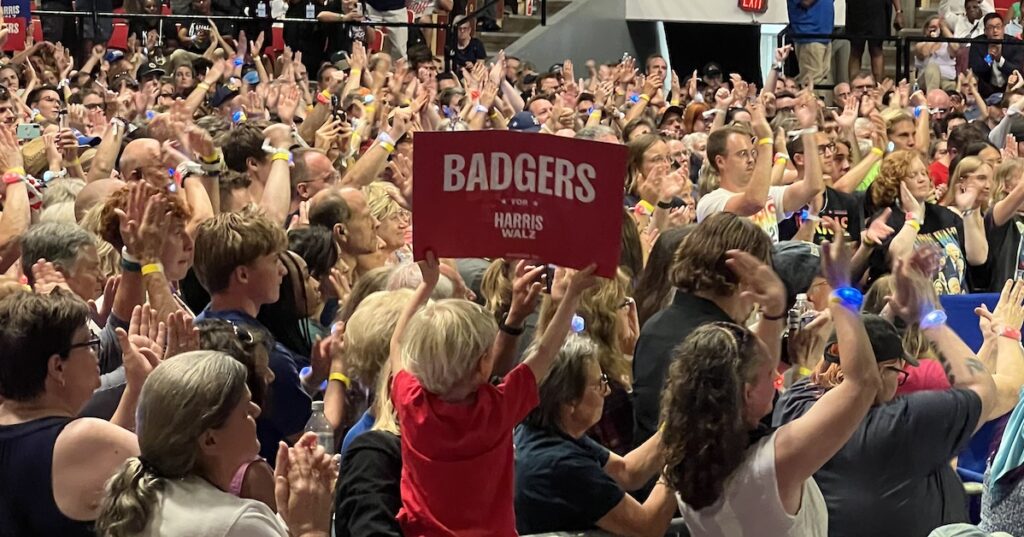 Supporters hold signs in support of Vice President Kamala Harris