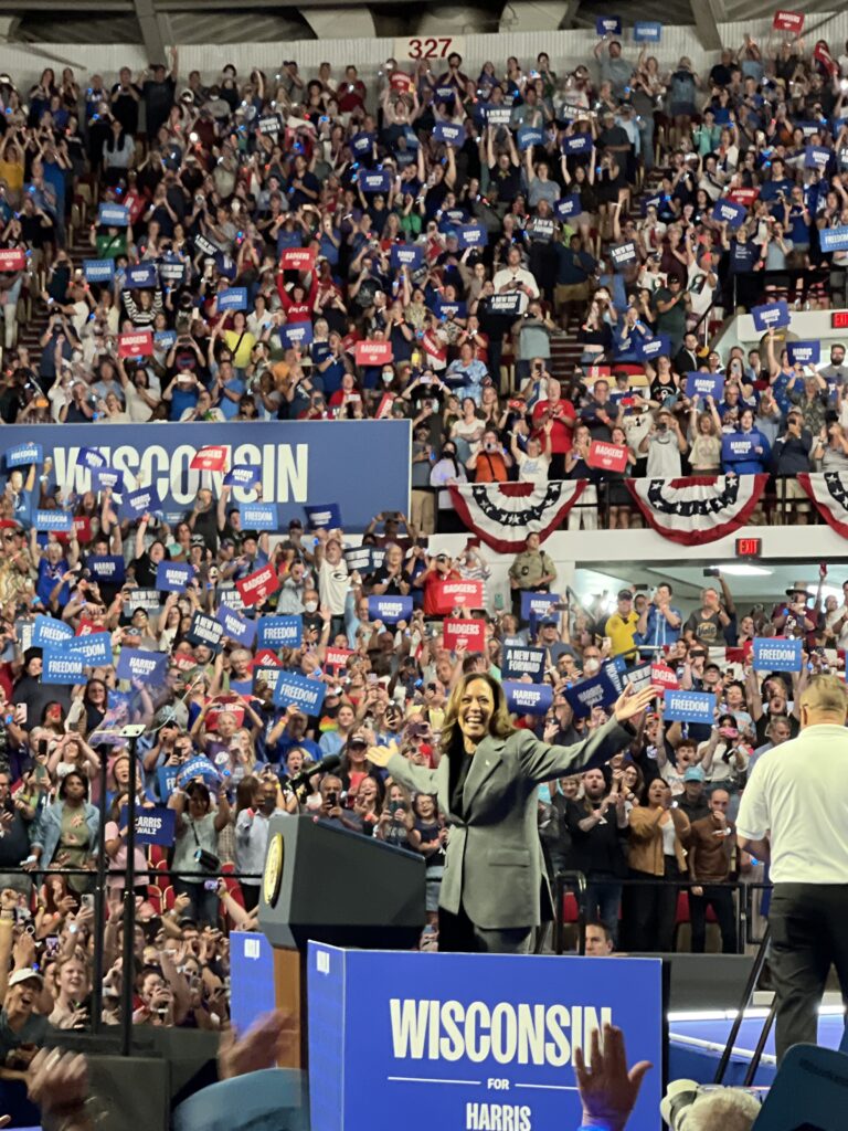 Vice President Kamala Harris waves to the crowd at a campaign rally at the Alliant Energy Center in Madison.