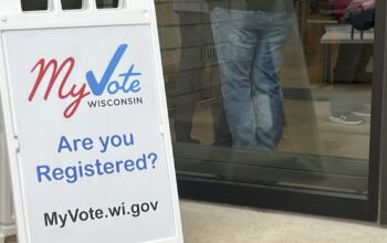 Voters in the Nov. 5 election wait to enter a polling place at the Waunakee Public Library.