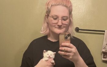 Kamrowski holding a kitten named Oreo Cheesecake.