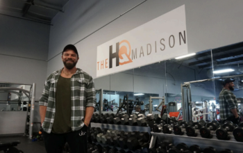 Josh Kosier stands proudly in the middle of The HQ Madison weight room