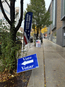 Voting signs outside library entrance.