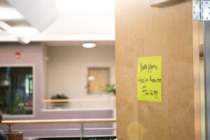 A yellow sign on a brown door reads "Youth Mental Health Fair"